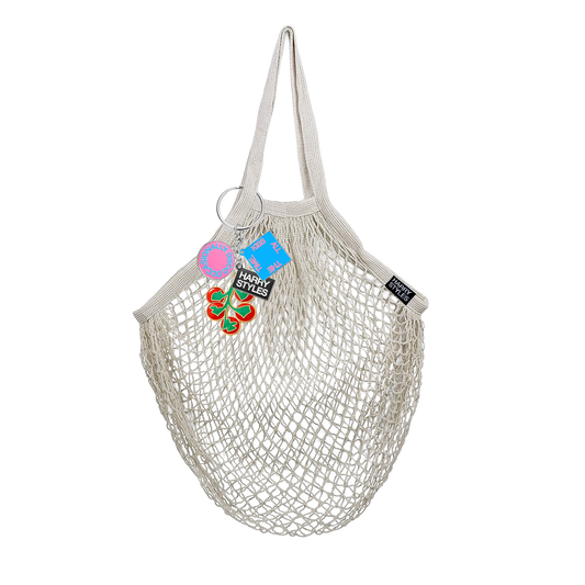Harry Styles mesh grocery bag with colorful disco themed charms tomato key chain and reusable eco friendly market tote design